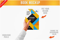 Book in Mans Hand Mockup