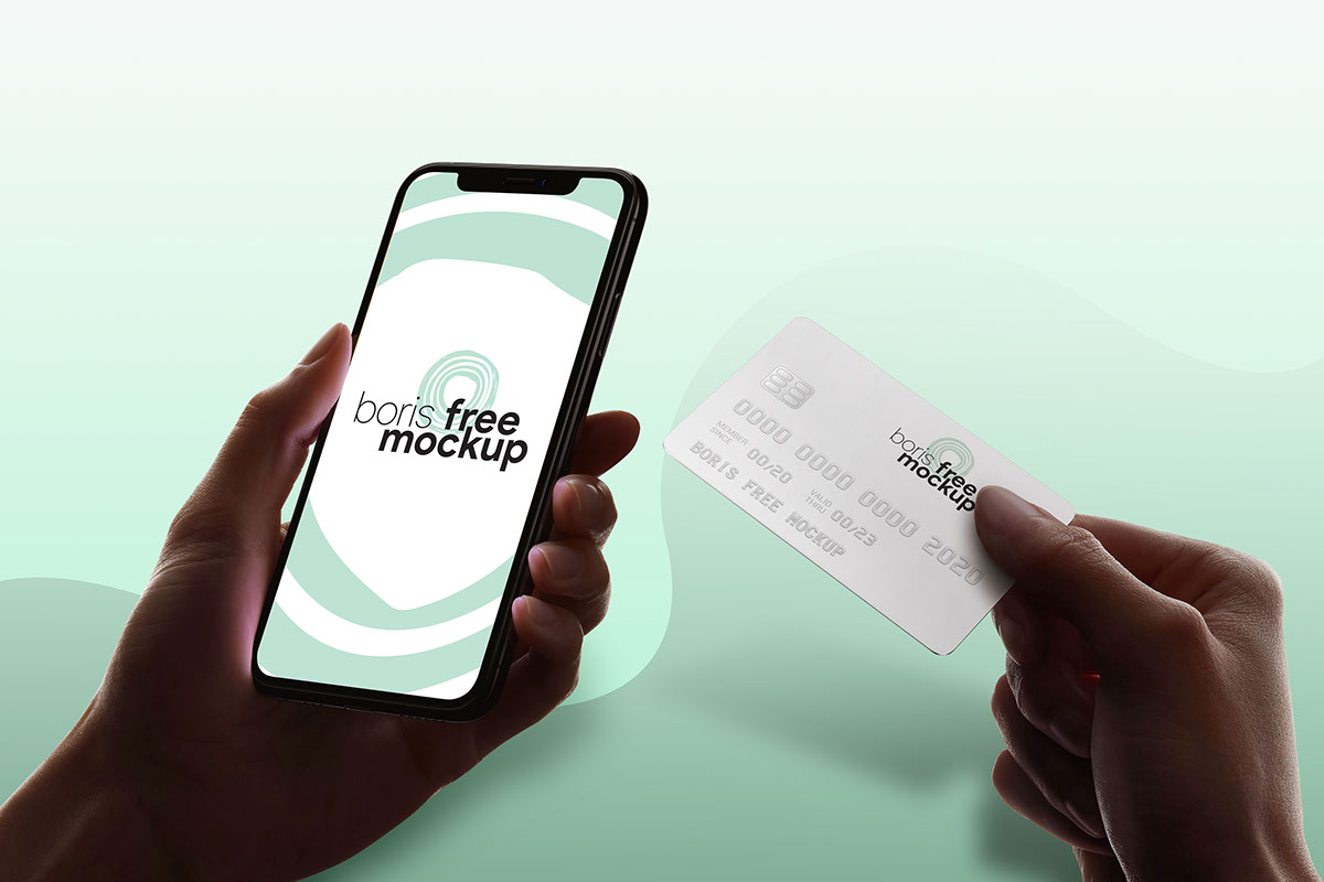 Free PSD holding iPhone and credit card mockup rendition image