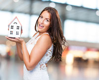 pretty-young-woman-showing-house-object