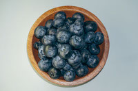 Azure Abundance Fresh Blueberries in Wooden Embrace by Raju C Reddy