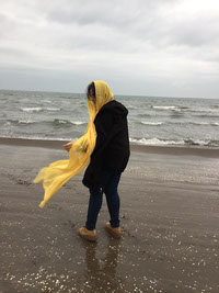 Girl in the wind on the beach