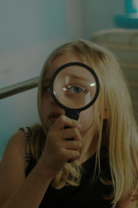 A girl with a magnifying glass