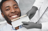 man-smiling-while-female-dentist-keeping-range-fillings
