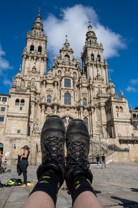 Boots in front the Cathedral of Santiago de Compostela celebrating the end of pilgrimage